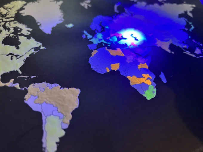 A page of the book shows a map of internet freedom status