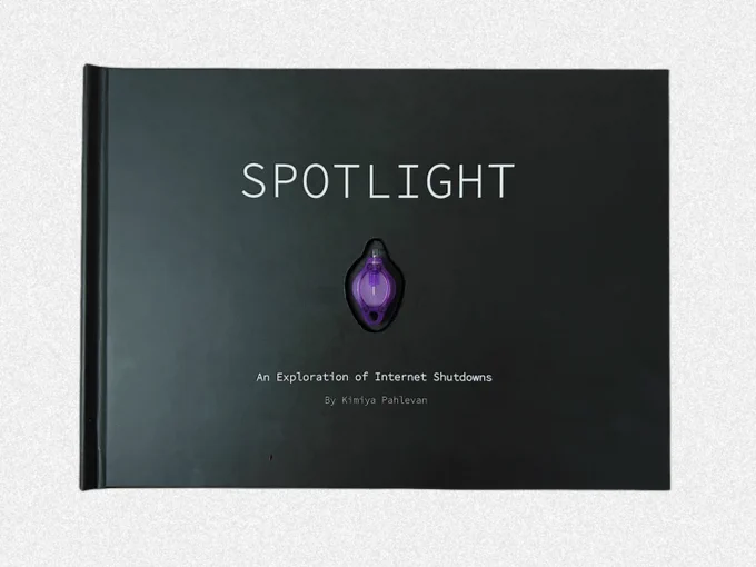 The book has a black hard cover with, in the middle, what appears to be a little ultraviolet bulb