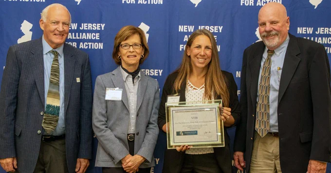 Representatives from the project teams gather for a photo with the award.