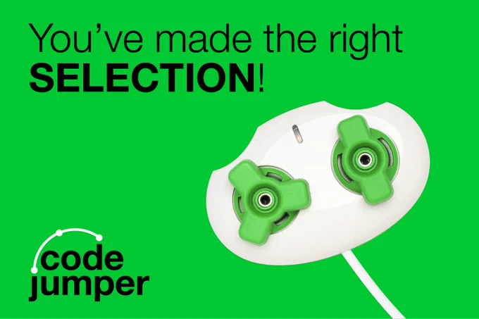 A white code jumper pod with two green dials on the top against a green background. One of the dials has two prongs, the other has three prongs. Text: "You've made the right SELECTION!" Code Jumper logo.
