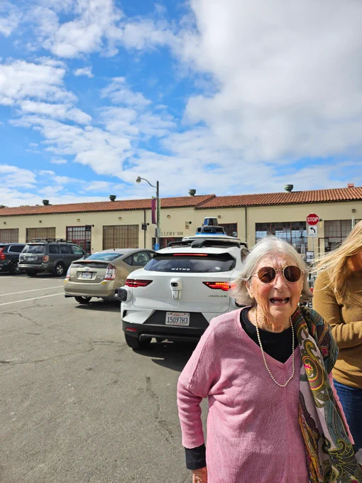 Grandma grinning after just getting out of the robotaxi. She wasn't sure if she wanted to ride when I first asked her, but she decided to go for it and had an absolute blast, as you can tell from her face here.