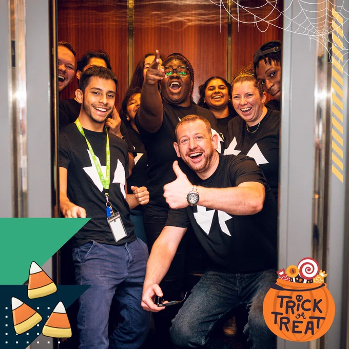 A group of people in an elevator having fun.