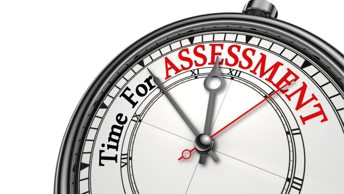 An analog stopwatch displays the words "Time for assessment."