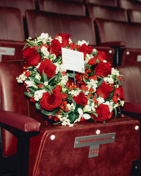 A wreath of red and white flowers sits on the seat of Sir Bobby Charlton in the directors' box at Old Trafford. A small accompany note reads: Loved, adored, never forgotten. Thank you, the Manchester United family.