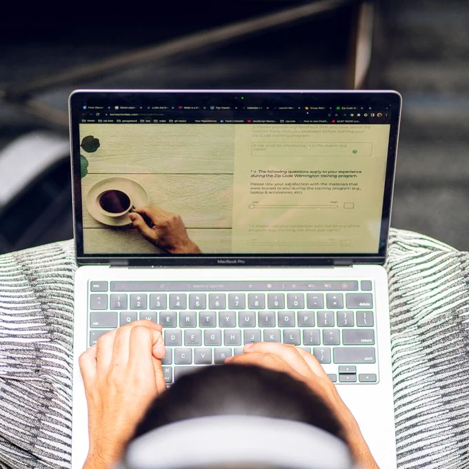 A person typing on an open laptop.
