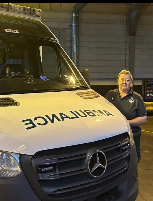 Paramedic Sharon in front of an ambulance