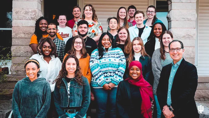A group of IU Maurer School of Law students and Civil Justice Design Fellows that works on this project gather together on steps outdoors and smile.
