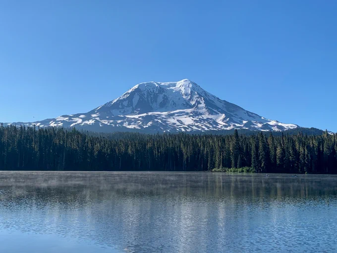 Takhlakh Lake in the foreground (with wisps of fog just above the water) and Mount Adams in the background.