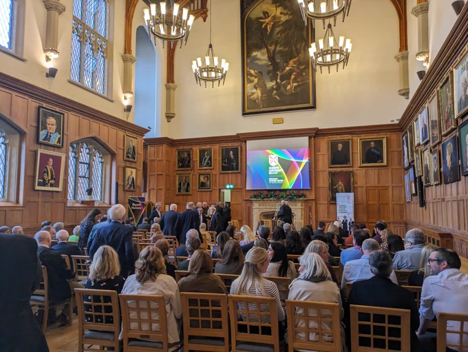 Attendees are taking their seats in the Great Hall.