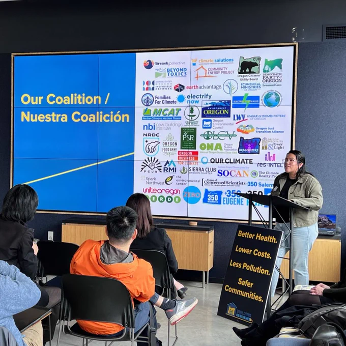 OJTA's Ana Molina standing in front of a PPT showcasing this campaign's many coalition partner logos.