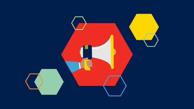 Hand holding a megaphone. Colourful hexagon design in background. 