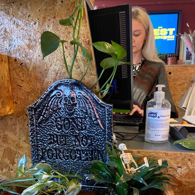 Pleasance box office with a small tomb stone which says 'gone but not forgotten'