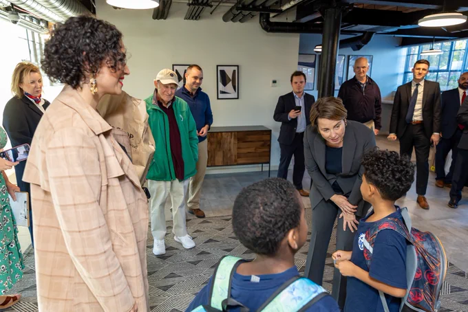 Governor Healey speaks with children inside housing development.