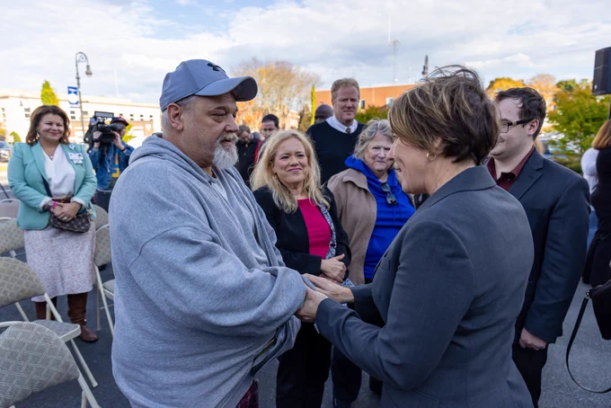 Governor Healey shakes man’s hand.