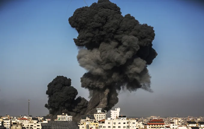 Black smoke rises above buildings following a missile attack.