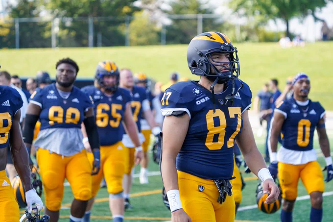 Windsor Lancers Football players walk onto turf before a game