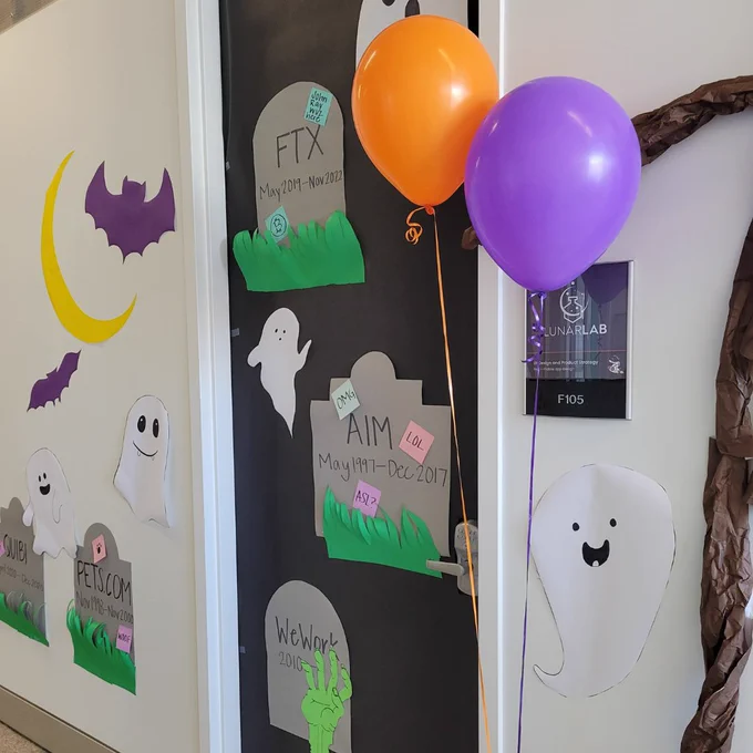 Lunarlab's door decorations! It's a Tech Graveyard (ooo spooky!). FTX, AIM, WeWork, Pets.com, and GUIBI are added. Lots of cute ghosts too. 