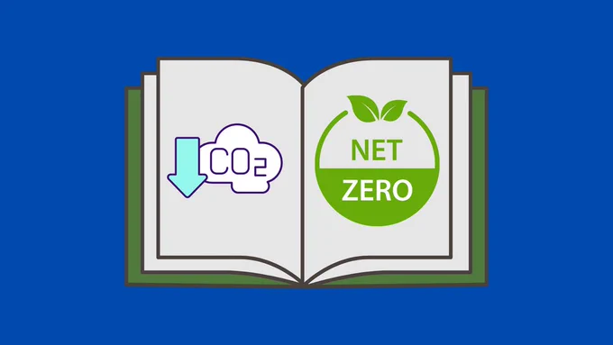 A book lays open. The left page displays a carbon reduction symbol, and the right page displays a Net Zero icon.