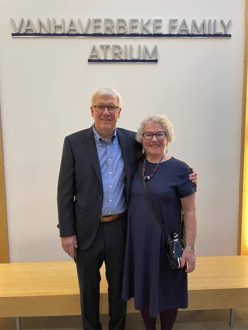 Ed and Sylvia Vanhaverbeke in front of the Vanhaverbeke Family Atrium sign.