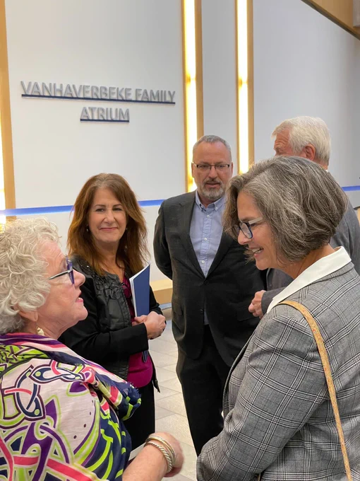 The Vanhaverbeke family talking to Ontario Tech staff and administration at the Vanhaverbeke Family Atrium event.