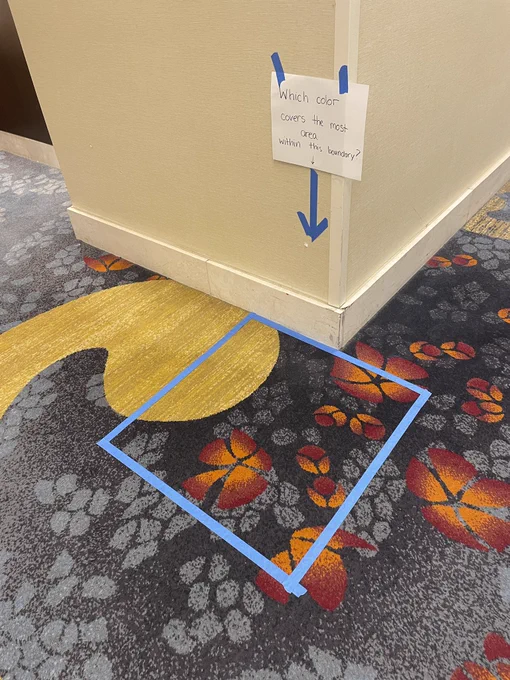 blue masking table outlining an area of carpet design to consider area and fractions