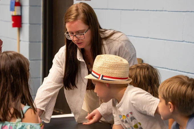 Summer scholar India Niehoff leads a group of kids in an activity about shipwrecks.