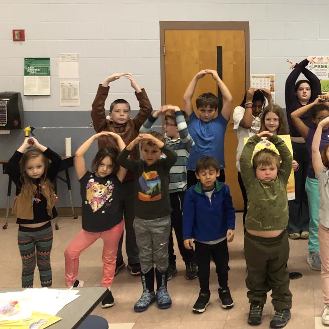 Youth posing as lightbulbs.
