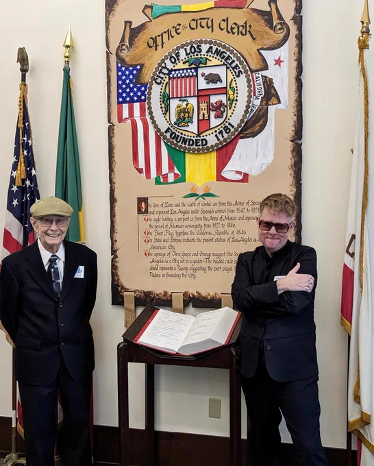 Kelly Besser and her father, stand near the signed Oath Book at the Los Angeles City Clerk's Office in City Hall, Oct 12, 2023.