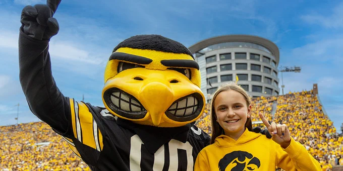 Herky joins UI Stead Family Children's Hospital Champion Kinley Albrecht at Kinnick Stadium for an Iowa goldout against Western Michigan.