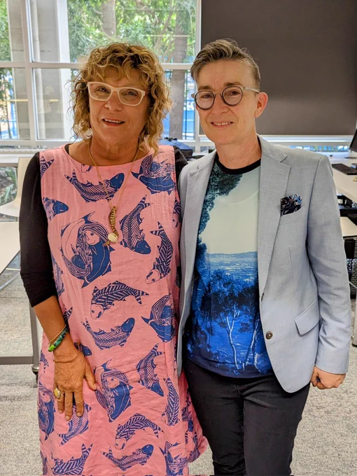 Photo of two people (Sonja Carmichael and Nicole Clark) standing in front of a window