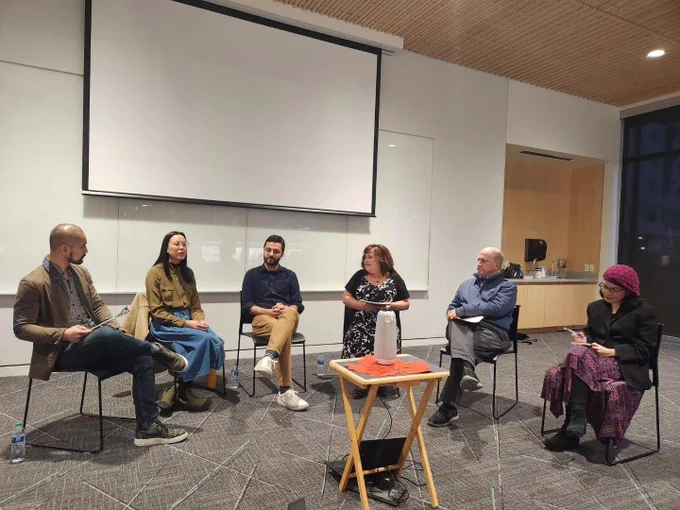 Sitting in a semi-circle, panelists discuss media literacy. From left to right: Di Zhang, Sarah Nguyen, Mert Can Bayar, Christie Fierro, Michael Danielson, Maliha Masood