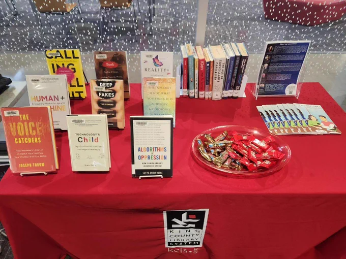 Library display showing books about the topic, with candy, over a King County Library System table cloth. 
