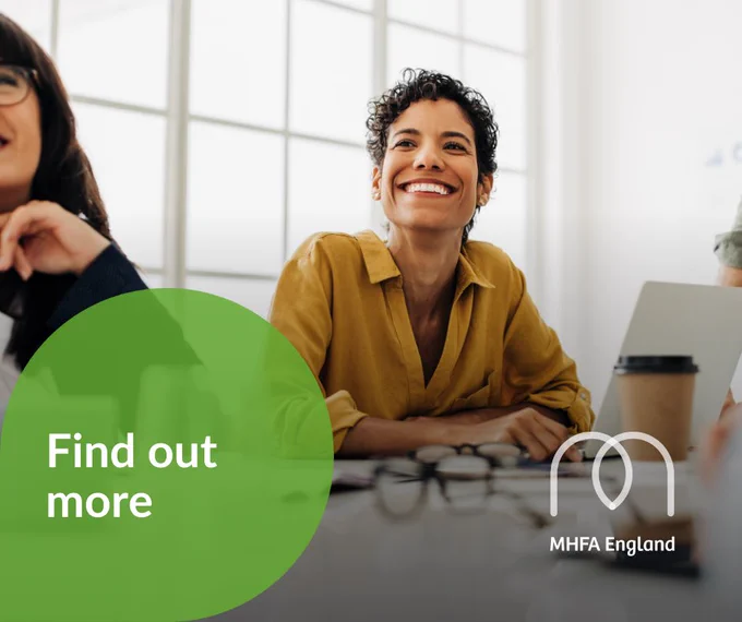 A woman looking up from her laptop, smiling. A green bubble from the bottom left corner says: Find out more.