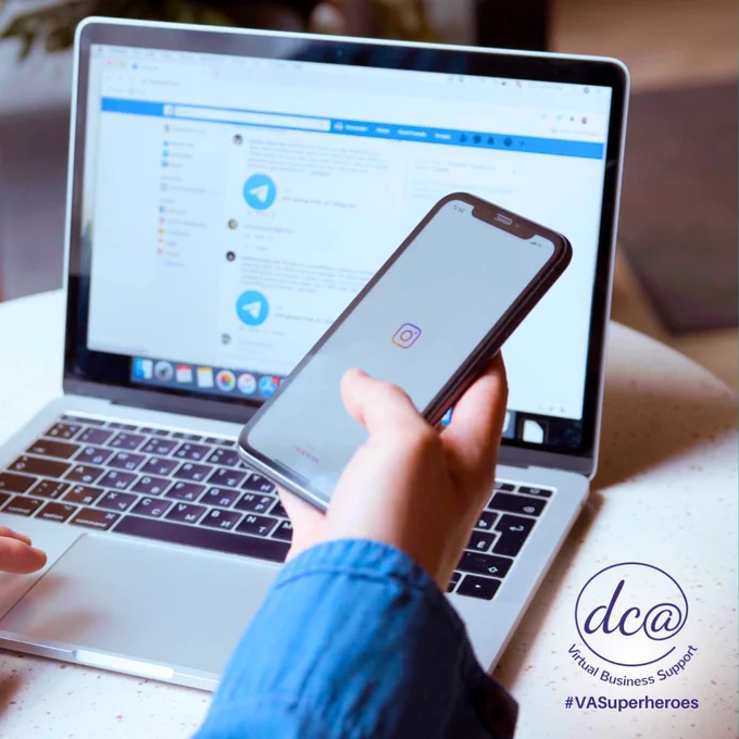 Image of a person opening Instagram on their phone, but also looking at content on their laptop. DCA Virtual Business Support. #VASuperheroes.
