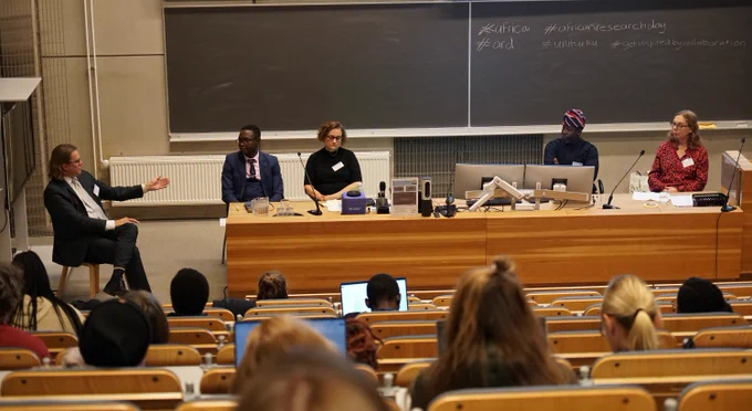 Panel discussion participants in front of the audience