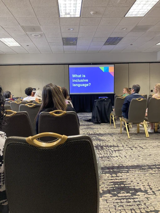 Slide of a conference presentation showing the question “What is inclusive language?”