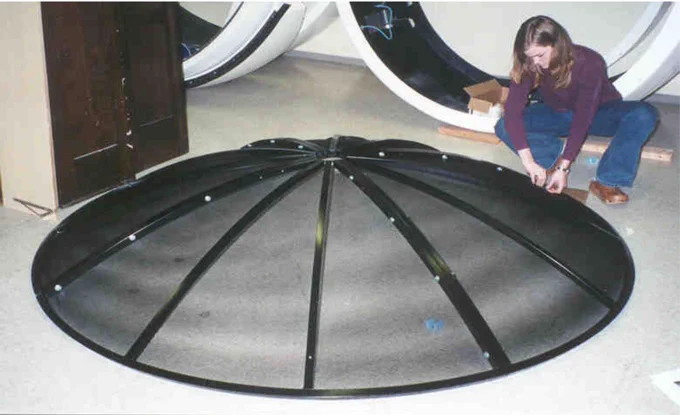 Dr. Bauer assembling the dish of the radio telescope she named Leroy at the University of Cincinnati when she was an undergraduate student.