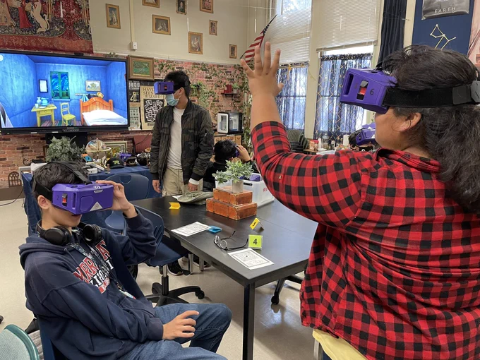 Students reach out for objects just beyond their reach while journeying though Virtual Reality.