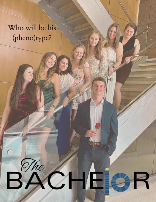 Seven female student line a staircase, staring down at one male student  (The Bachelor) who is holding a rose.