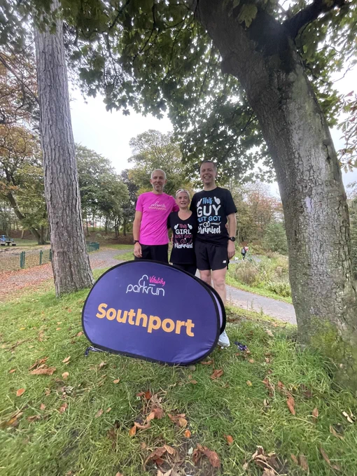 Kelly and MiKe stood with Simon in front of the Southport Parkrun sign. My t shirt says ‘this girl just got married’ and Mike’s says ‘this just just got married’