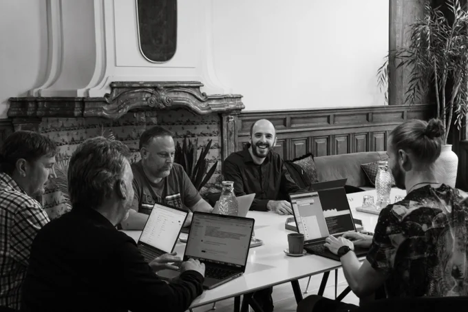 This is a picture of the Infuse Video team working on their computers, during an IRL session. The picture is in black-and-white.