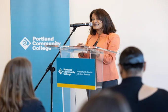 Commissioner Jayapal is speaking behind a podium at the PCC opportunity center grand opening