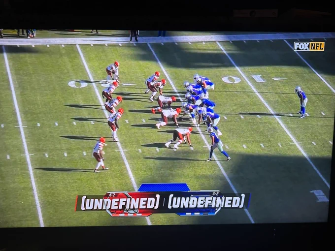 Photo of a tv watching the Browns vs Seahawks game with a score overlay that says “(UNDEFINED) (UNDEFINED)”
