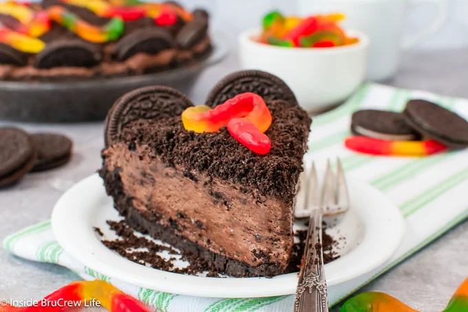 A slice of chocolate pudding pie on a white plate.