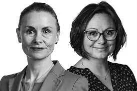 A black and white photo of Professors McDowall and Doyle both smiling to the camera.