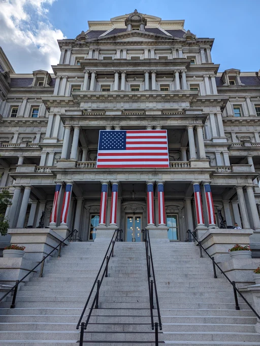 The EEOB view up the Navy Steps with US flags.