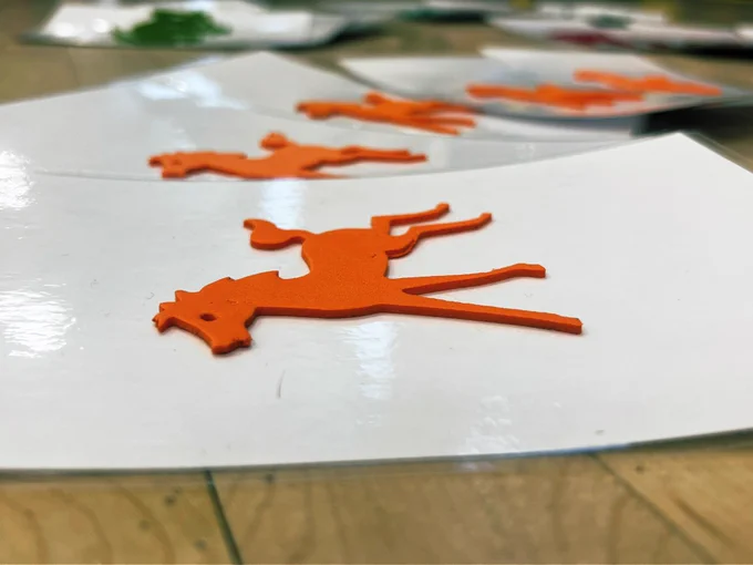 An orange horse is shown raises on a laminated 4x6 notecard.