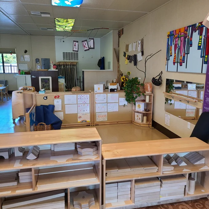 Classroom at All Five School with shelves in the foreground.