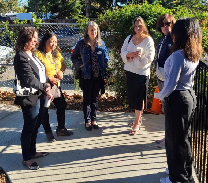 Tour group in conversation with "teacher Ana".