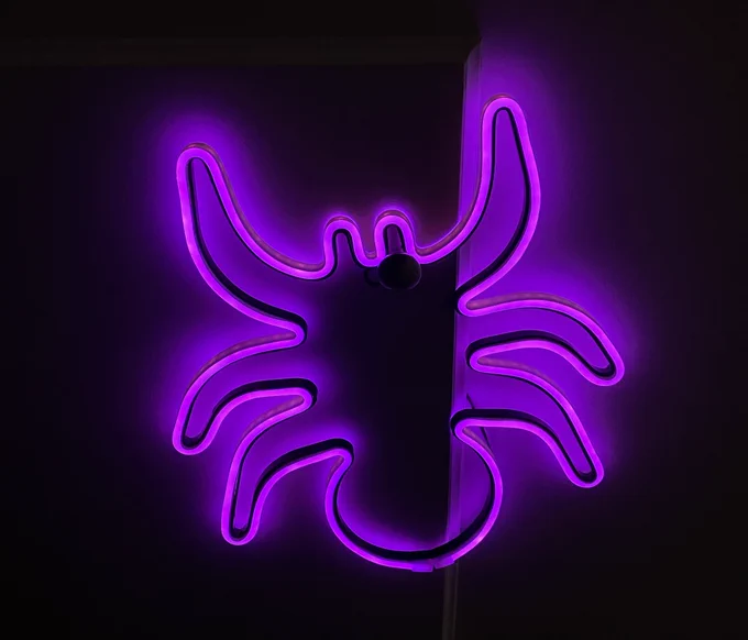 Neon purple spider Halloween decoration, but with only 6 legs instead of 8